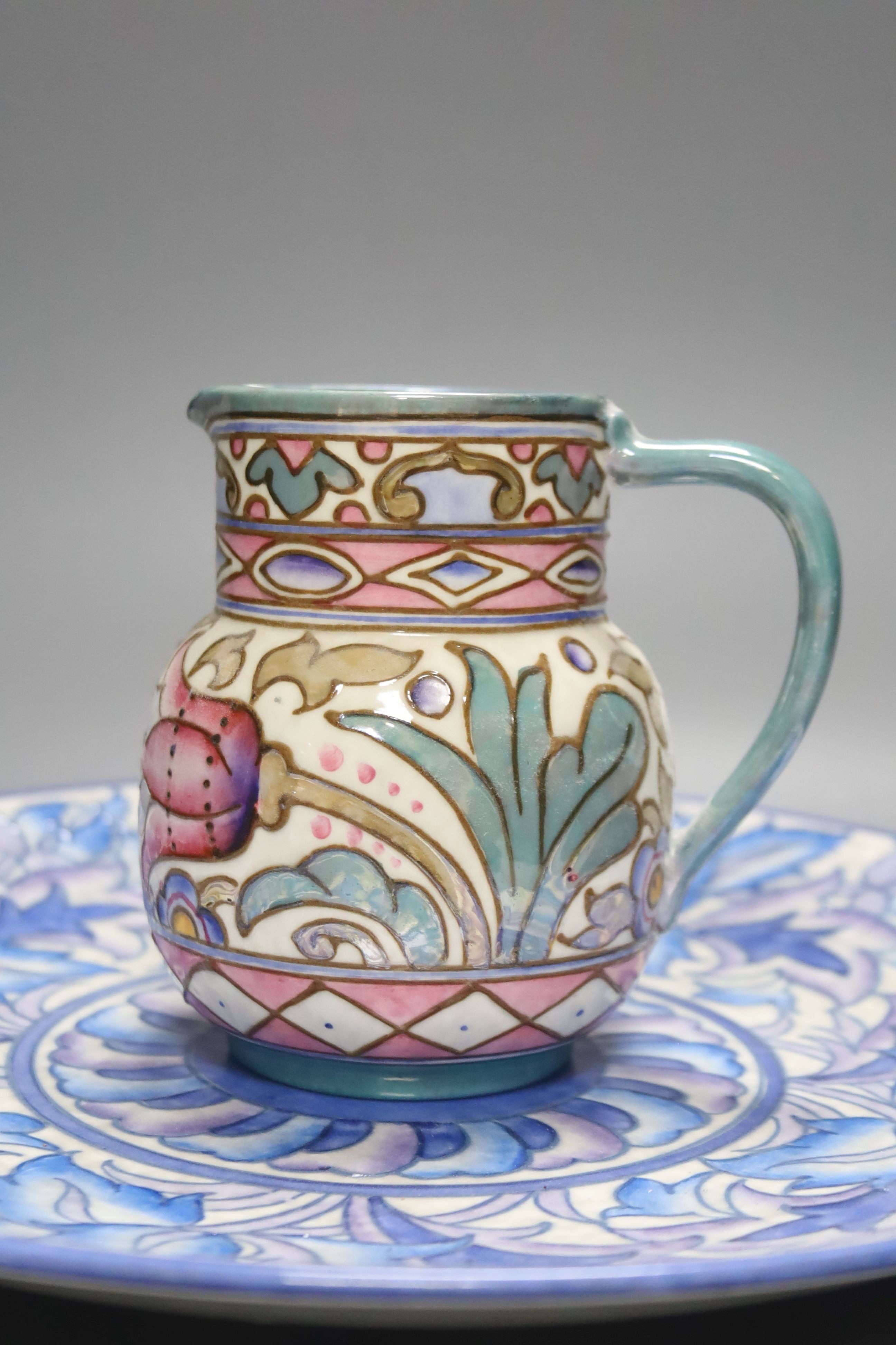 A Burleigh ware Charlotte Rhead lustre jug and a Crown Ducal dish, diameter 32cm